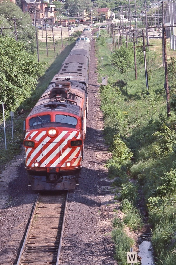 Candy Stripes in foreign territory: GMD 1953 built FP7A, ex CP Rail, #1404 & a sister in charge of VIA #1 ...


   … on final approach to the CN Newmarket station stop, June 2, 1979 Kodachrome by S.Danko


   Noteworthy: In this image the VIA Train #1 – CANADIAN -  has only 15 remaining daily trips on the CN Newmarket Sub (south of Washago and from Washago north on the Bala Sub to CN Boyne (CP Rail Reynolds) near South Parry).


    The June 17, 1979 timetable re-routed the daily VIA #1 & 2  CANADIAN exclusively onto CP RAIL Vancouver (CN station) through Banff to/from Montreal (CN) Central Station. 


   and concurrently daily trains  #3 & 4  SUPER CONTINENTAL exclusively on CN Vancouver through Jasper to/from Toronto Union. 


   VIA trains 1 & 2, 3 & 4: The June  17 1979 re-routings were only in place a couple of years, by June 1982 the SUPER CONTINENAL disappeared completely, replaced by 10 regional trains.


   VIA #1 & 2 remained on CP RAIL through to the January 1990 debacle that slashed more than half of VIA services – thanks to YOUR Canadian Federal Government 


   Ponder: Wasn't VIA's original purpose to promote rail passenger travel ? However all VIA has done is reduce / divest services and continues to do so.....hmmm....
 

  Foreign: 


      bemused 


   sdfourty