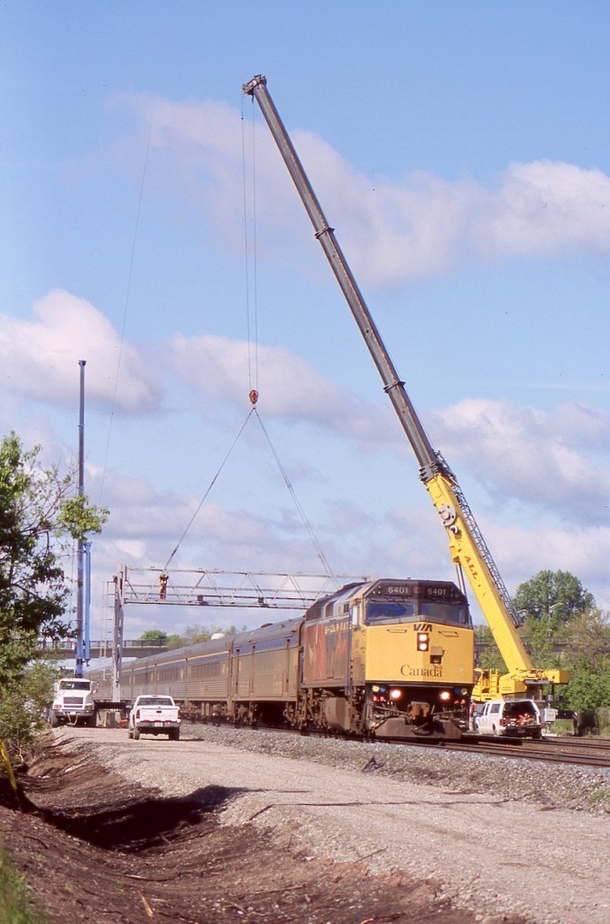 By this date upgrades along the Oakville subdivision were well under way to the point that the old switches and signal bridge at Aldershot West were in the process of being removed. This day cranes were busy disassembling the signal bridge as VIA train 70 with Spiderman 2 decorated F40 6401 rolls underneath.
