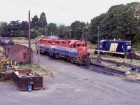 The rail lines on Vancouver Island have sadly been on a gradual decline. CNR pulled out first and CP’s lines slowly followed to the point that only VIA Rail used most of CP’s route. During my visit in 2003 only the VIA RDC’s were running and we only got one chance to photograph the run. Years of deferred maintenance along the line finally caught up with VIA, and while the passenger trains were popular and often full, they were discontinued a couple years later. Many years earlier CP passed its lines over to RailAmerica, and in this view the lack of revenue traffic in the yard was a sign that RA would soon give up the operation as well. Today limited freight service still survives under another operator borrowing a pair of GP9’s from the SRY. The two GP38’s in the yard this day were waiting the call to duty another day. The 3870 is somewhat unique as it was part of a group ordered by Penn Central with dual control stands. The cut out on the front of the cab denotes this. As for the Railink 2099 it should look familiar to anyone Railfaning Brantford and the Hagersville subdivision after Railink took over operations on the line in the late 1990’s. It is interesting in that it was built as a GP20 for the CB&Q. By the time Railink picked it up it was rebuilt into a GP9 and numbered 1751. After a few years it headed out west. I believe it was scrapped years ago. 