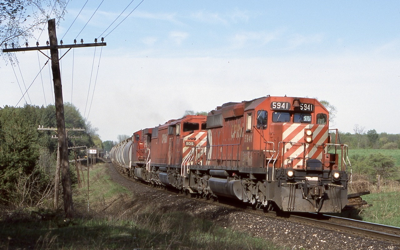 There was a time when CP would run unit Potash trains to Putnum. While six axle power isn’t allowed on the St. Thomas subdivision these trains would typically run to the siding at Coakley then leave the train for the four axle locals to gradually finish the trip to Putnum in sections. Here the unit train is seen rolling through the curve at mile 54 east of Killean with a SD40, SD40F and AC4400.