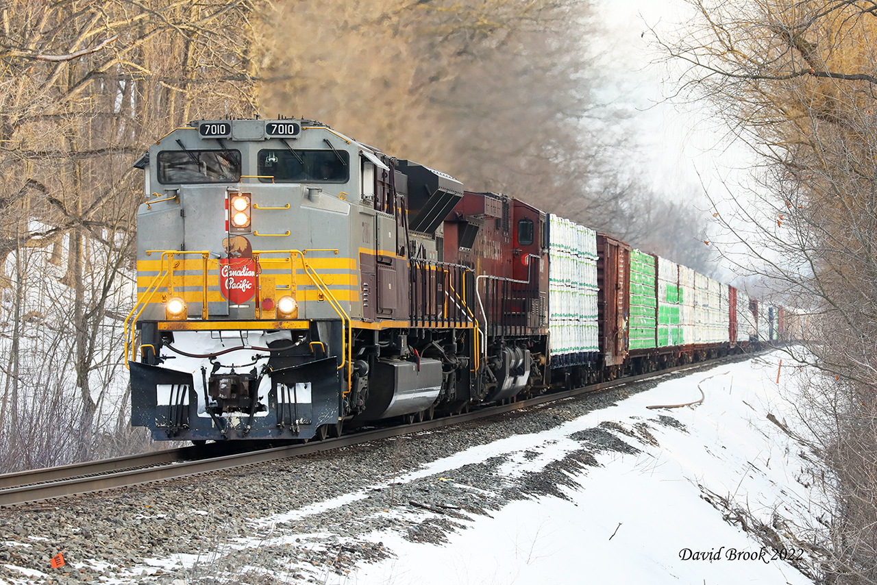 7010 has been running around Southern Ontario for the last week or so; teasing us yesterday as a possible 246 before going back to Toronto Yard. A quick peek at ATCS this morning showed 235 climbing by the Ski Hill meaning there would be plenty of light by the time it got to Galt. "So you're saying there's a chance".
So here it is climbing Orr's Lake Hill with the aid of 8641. It's always great when they lead.