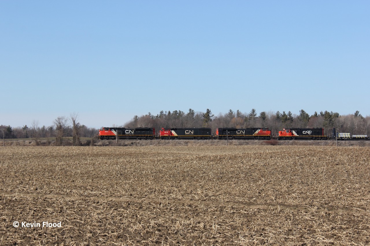 Just west of Copetown, Ontario, a CN westbound is pictured cresting the grade with four units - CN 8825, BCOL 4618, CN 8003 & GTW 5934 - on a beautiful late winter afternoon.