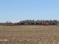 Just west of Copetown, Ontario, a CN westbound is pictured cresting the grade with four units - CN 8825, BCOL 4618, CN 8003 & GTW 5934 - on a beautiful late winter afternoon. 