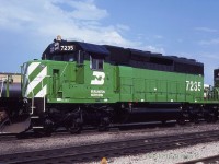  During the summer of 1980 the GM/EMD plant at Lagrange IL was at full capacity pumping out SD40-2's for Burlington Northern. To speed up delivery it was decided to construct two batches (7167-7235, 8075-8089) at GMDD London.  Here 7235 the final from the first batch is at the CP in Windsor. It, along with 7234 will be lifted by the C&O Puller. A spotting feature of the Canadian built units was the smooth sided traction motor blower bulge (behind the cab). The US built units had two horizontal strengthening bars.   