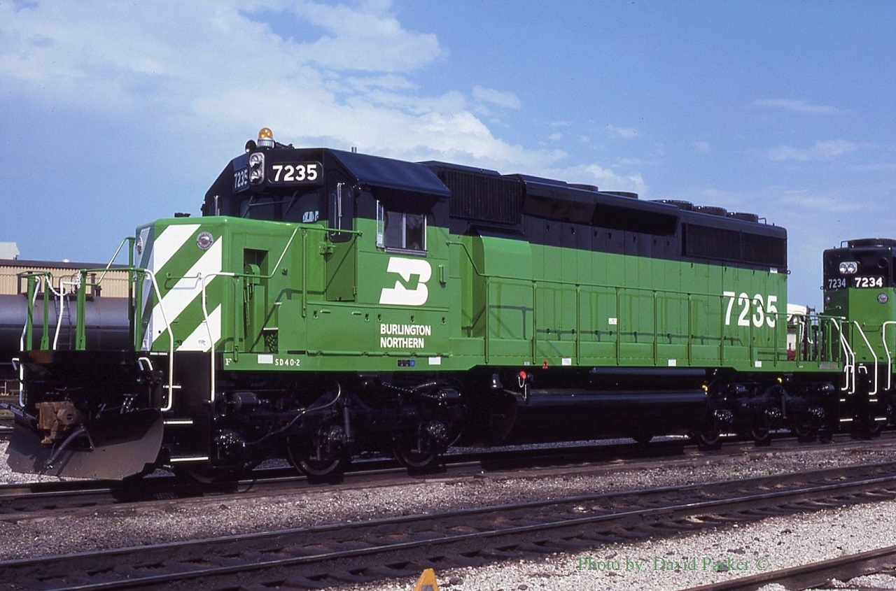 During the summer of 1980 the GM/EMD plant at Lagrange IL was at full capacity pumping out SD40-2's for Burlington Northern. To speed up delivery it was decided to construct two batches (7167-7235, 8075-8089) at GMDD London.  Here 7235 the final from the first batch is at the CP in Windsor. It, along with 7234 will be lifted by the C&O Puller. A spotting feature of the Canadian built units was the smooth sided traction motor blower bulge (behind the cab). The US built units had two horizontal strengthening bars.