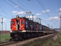  The "Air conditioning" is on full blast and a friendly wave from the motorman of an afternoon Westbound commuter train powered by a pair of English Electric boxcabs at CN Jct D L'Est in Montreal. 