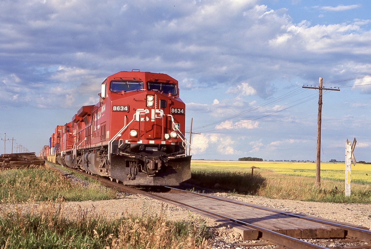 While the sight of three relatively clean AC4400’s  certainly were not worth writing home for. The overall scene is what made the photo for me, with a canola field in the background and thunderheads rapidly forming in the distance. Ashbury was once the location of a siding for CP, but it was removed. The clouds would only increase in size as we headed for Winnipeg this day, completely soaking us as we raced into the hotel.