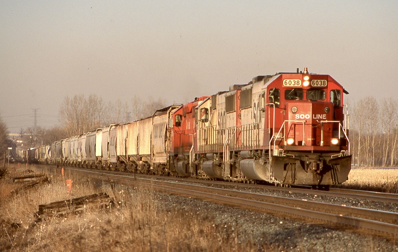 Late afternoon light shines on a westbound CP freight as it storms out of Hornby dip, with a good cut of grain cars on the head end. This days power is a pair of SOO SD60’s and a CP SD40.