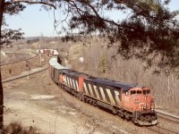 Despite its reputation at times, I have always like spending time at Hamilton West. While at first glance the location seems to never change, there has been a number of changes here over the years. The first being the location name. With the upgrading of the Oakville subdivision came the elimination of the plant known as Hamilton West. Today it is simply an extension of Bayview Junction. The old searchlight signals were eliminated as well with new hooded LED lights installed here. Sadly all variations of “Cowls” on Cn have been retired making this Dash-8/SD60 combo on 390 impossible to replicate today. The classic green bridge sides over highway 403 have also been replaced and the tree here I have framed many trains with over the years is now dead and gradually falling down. 