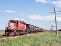 In an image that could also be in the 1980’s, here an empty grain train with a lone multi mark SD40 with almost a full train of Canadian built cylindrical hoppers round the curve at a location I had on the slide as Guiler. Looking now on google maps I can not find the location but it was along the mainline along the Trans Canada highway. 