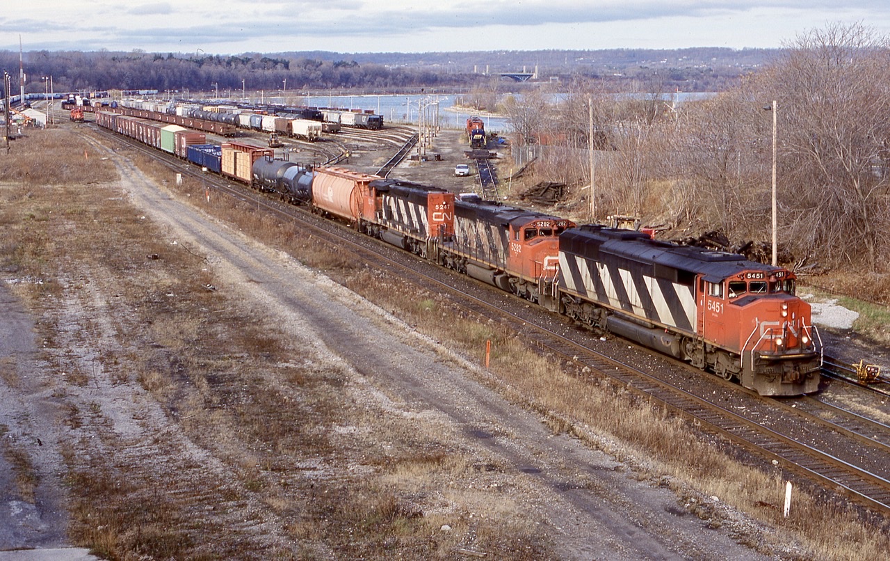 Railink was still pretty new by this date and CN still had a line local assigned to Hamilton in the form of 555. Just out of view to the left is the engine house. Railink power around this time was mainly old GP9’s and former CN M420’s. RLK 4205 can be seen in the distance in the yard while CN 555 has just entered the main in the background with a pair of GP9RM’s. CN 449 later replaced by 339 has a nice set of “stripes” in the form of a SD50 and 2 SD40’s as the stop long enough to work the yard before heading to the Niagara region.