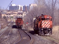 The difference of a quarter century. It is always amazing how much things can change over a couple decades. By the mid 1990’s I finally had my own car and a decent camera. Streetsville was often a good place to stop after college or later on a day off. Typically by mid morning the “Streetsville turn” had made it to town from Guelph junction. In the mid 90’s standard power for the job was a single C424 or RS18, and both Guelph and Streetsville junctions had a wye if need to turn the power although it was rarely used. The scene here at the mills has changed a lot over the years. The large church in the distance has been long completed, and the housing development in the background is now filled in with a new mature tree line.  Both spurs to the right and left have been severed and long unused. It’s hard to believe considering the ADM mill off the spur to the right was once switched daily. The flange lubricator on the mainline here was also moved further west. As for C424 4227 it and all surviving MLW’s would survive one more year, as for 4227 it is still active today and used by the Apache Railway. Within a year the Streetsville job would be abolished along with the job to Guelph. Ontario Southland would take over operating the line to Guelph as well as storing its power in Guelph junction. A new stone train would serve Guelph junction from Toronto, while another train would serve Streetsville from Toronto. In this image CP 4227 is in the process of backing down the ADM spur. Eventually pairs of rebuilt GP9U’s would take over for the ailing C424’s and RS18’s. Today ADM still owns its elevator, while Reid’s mill would sell out first to Kraft and later to Ardent. Ardent still receives cars on it’s surviving spur a couple times a week. 