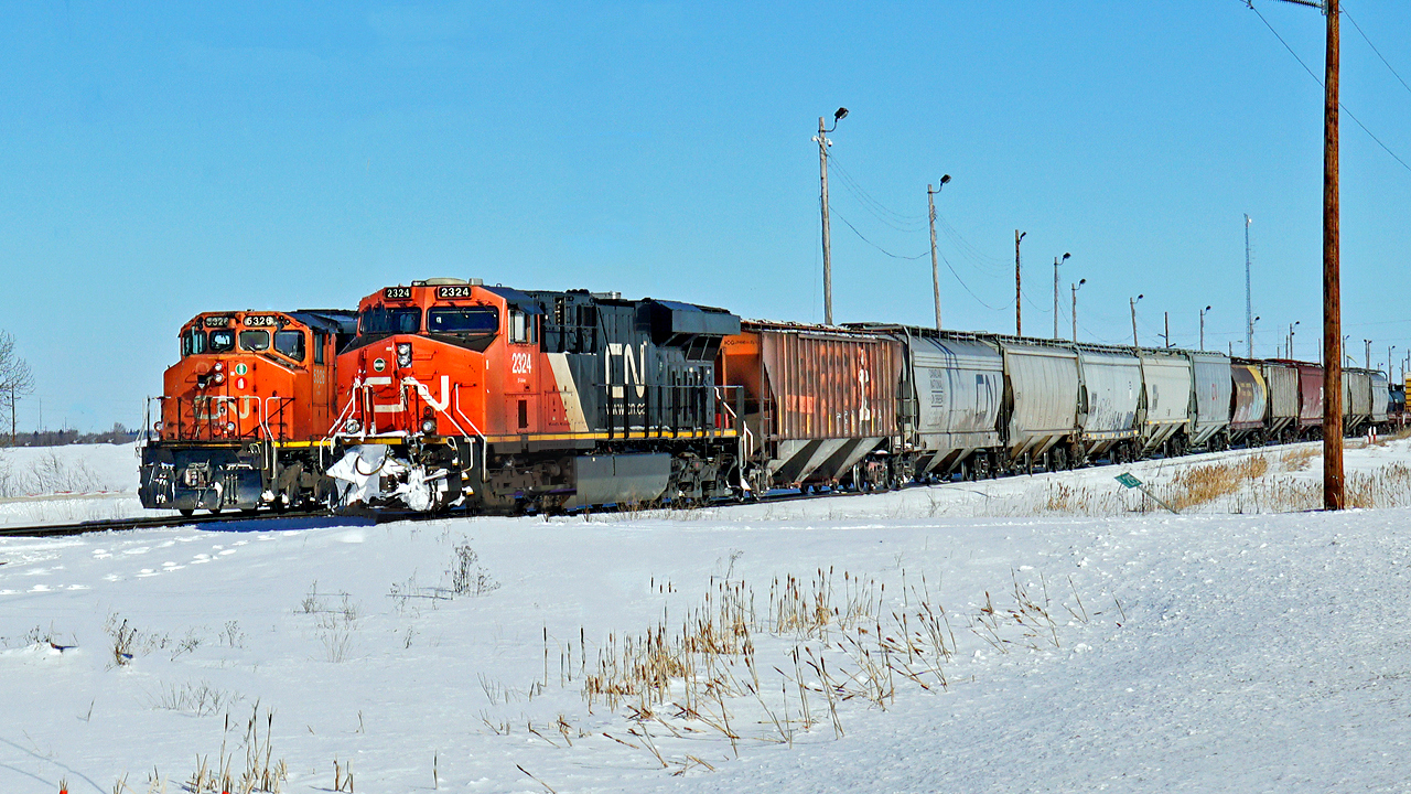 ES44DC CN 2324 sits at the head of 411 on the Scotford bypass while SD40-2(W) CN 5326 runs behind light engine.