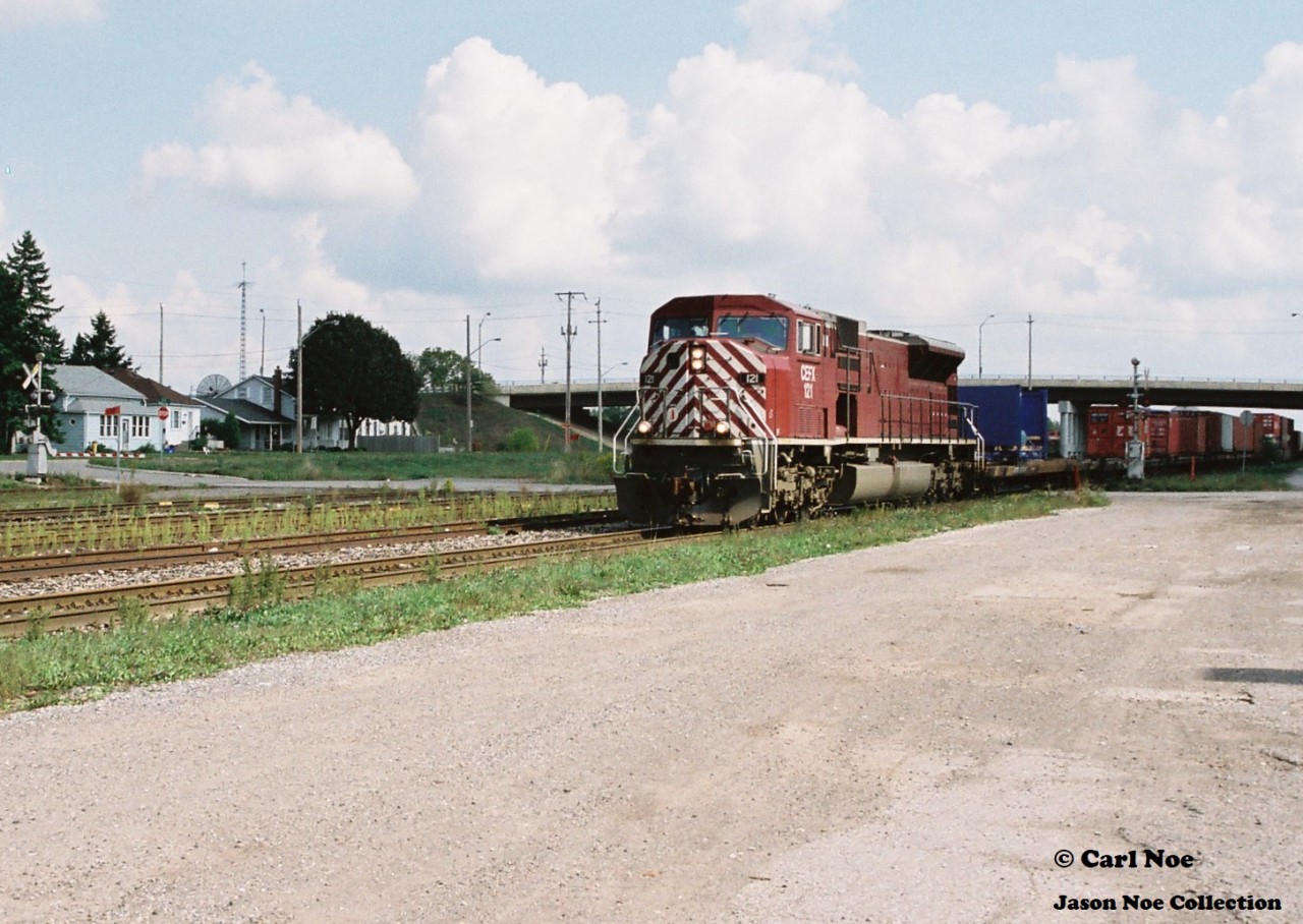 CIT Group/Capital Finance (CEFX) SD9043MAC 121 leads a westbound Canadian Pacific intermodal train at Galt, Ontario in late summer 2001. In later years this unit would become NS 7333 and was eventually converted into an SD70ACU.