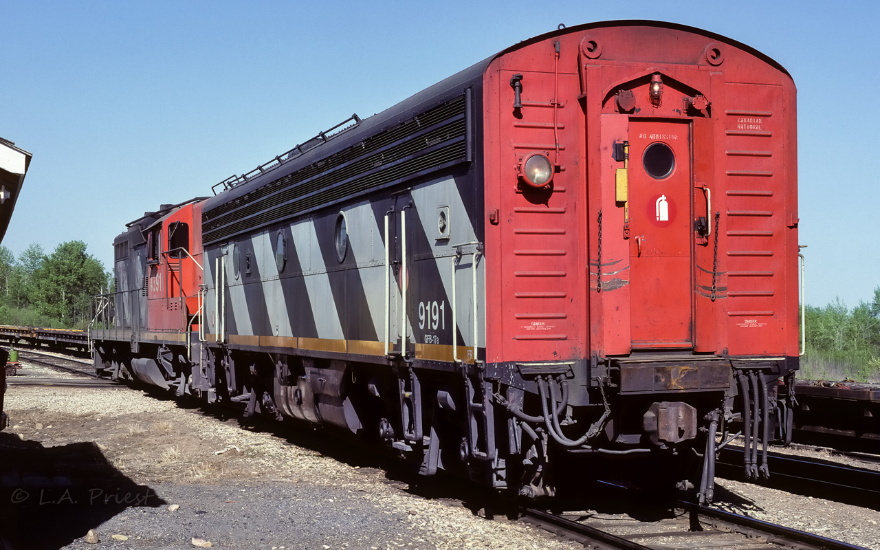 The fuel train had an extra chore in Redwater today. They stopped here at 16:00 and filled our siding with empty flats (seen behind the 9191). They then left the fuel tanks on the main west of town and went to Kerensky and filled the siding there with empty flats. After all that, they came back, rounded up the rest of the crew and went for dinner at the Redwater Hotel. It is 17:30 in this photo and I'm making hay while the crew is busy inside. They continued on their way east to Cold Lake at 19:40, they serve good dinner at the hotel :^). In this photo, we have the front end of the 9191, nice big single sealed beam. This B unit is formerly the 9031 and was re-built in 1972. At the front is the 4391. It is formerly the 4150 and was just re-numbered to 4391 in 1984. In 1991 it will go in for a re-build and become the 7029, which it seems, is still working today. These 2 units have a nice roll of 91's going. Shot at the section shack, Redwater, with Kodachrome 25 film.