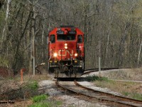 CN GP38-2 4725 solo catches a sunny break as it crosses the pedestrian friendly Iron Horse trail in the heart of Victoria Park in Kitchener as it heads to work the last remaining customer on the Huron Park Spur, which is Ampacet Canada.   


