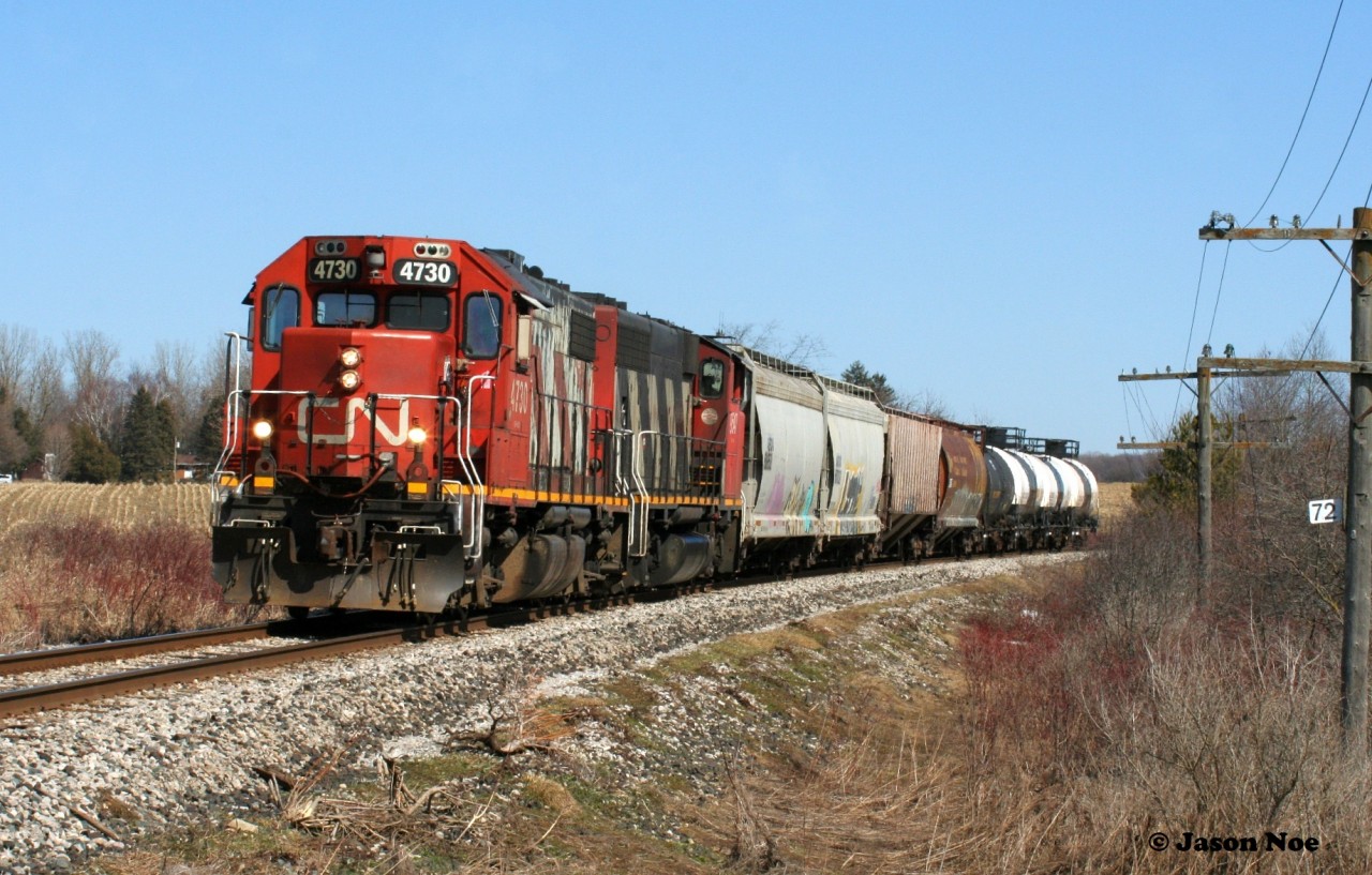 CN L568 with 4730 and 9547 passes Mile 72 in Baden, Ontario as they head westbound to Stratford on the Guelph Subdivision.