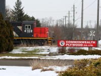 Thanks to a reportedly faulty switch on the ION, CN L566 had timed-out overnight with CN 4102 with the crew making it as far as Randall Drive in north Waterloo. A daylight curfew prohibits CN movements on the ION portion of the spur, so in turn L566 couldn’t resume its trip back to Kitchener until 23:00 with a fresh crew. Thankfully, the seemingly endless winter overcast had parted briefly to illuminate CN 4102 as it idled away at the crossing as seen just after 13:00. Now much like decades prior, CN GP9RM’s are still operating on the spur despite all the changes that have occurred to the line. However, unlike the 1990’s it now takes an extreme circumstance to photograph one in daylight between Kitchener and Elmira. 
<br> 
Commonwealth Plywood was a regular customer on the CN Waterloo Spur in the pre-GEXR era and then saw semi regular service during the GEXR era from 1998-2018. However, since CN’s return in 2018 they have not received any carloads. As of 2022 their small siding is still intact and in place. 
