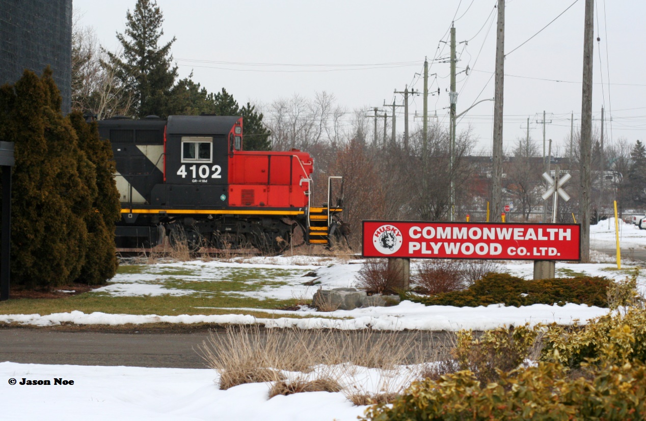 Thanks to a reportedly faulty switch on the ION, CN L566 had timed-out overnight with CN 4102 with the crew making it as far as Randall Drive in north Waterloo. A daylight curfew prohibits CN movements on the ION portion of the spur, so in turn L566 couldn’t resume its trip back to Kitchener until 23:00 with a fresh crew. Thankfully, the seemingly endless winter overcast had parted briefly to illuminate CN 4102 as it idled away at the crossing as seen just after 13:00. Now much like decades prior, CN GP9RM’s are still operating on the spur despite all the changes that have occurred to the line. However, unlike the 1990’s it now takes an extreme circumstance to photograph one in daylight between Kitchener and Elmira. 
 
Commonwealth Plywood was a regular customer on the CN Waterloo Spur in the pre-GEXR era and then saw semi regular service during the GEXR era from 1998-2018. However, since CN’s return in 2018 they have not received any carloads. As of 2022 their small siding is still intact and in place.