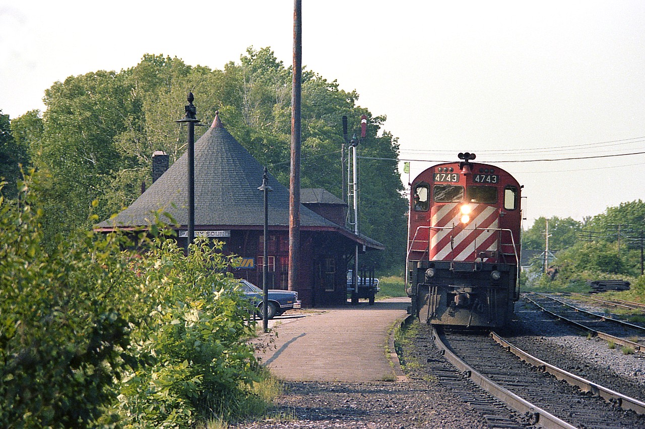 Southbound CP 4743 with 4719 stopped at Parry Sound CP station in order to set off a couple of tank cars in the diminutive yard for local industry.  Times have changed. These days, there not only is no longer a 'yard' so to speak, there is only one mainline track as well. The beautiful station hangs in though, and has been repurposed.
Last I knew it was a commercial concern; an 'Art Gallery" business.