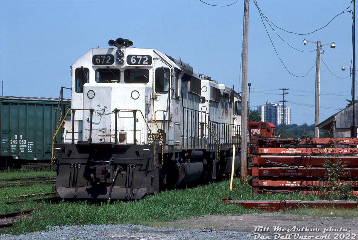 CP SD40-2 units 672 and 673 sit in Aberdeen Yard between duties, still wearing their previous owner's colours and roadnumbers.

CP's motive power expansion policy in the early 90's seemed to be leasing, or acquiring secondhand power, and the reliable SD40 was their building block of choice. A few groups of secondhand units were leased and/or picked up from the likes of QNS&L, GATX, NRE, Helm, and rebuilder MK Rail. CP scooped up seven former KCS SD40-2 units, 670-676, via Helm in 1992, which were quickly patched and operated with their old numbers until eventual renumbering and repainting as CP 5415-5421. Two units, 671 and 672, were never repainted and wore KCS white patched with new numbers 5416 and 5417 until retirement.

Of the two units here, 672 (5417), and 673 (5418) were sold to NRE, and 5417 was eventually resold to Ontario Northland (apparently as an engine test-bed unit, but it was found to be in operable condition and was put into service as