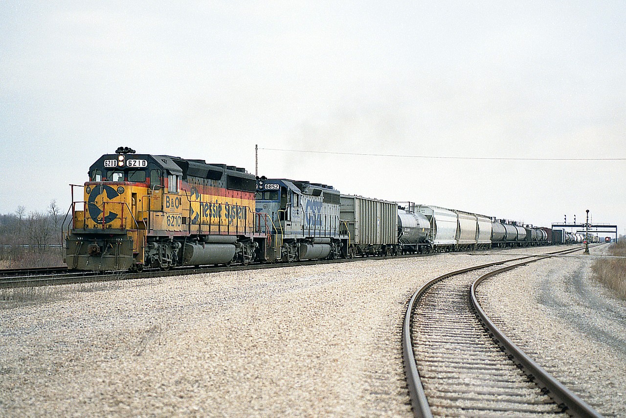 I'm down by the PCHR (now GIO-Trillium) connector mile 18 or so just west of the Welland canal; and the westbound #321 is rolling by with Chessie B&O 6210 and CSX 6852. I didn't see many of these 'stealth' type paints along this line. On the right, distant, you can see a CN local on the way.