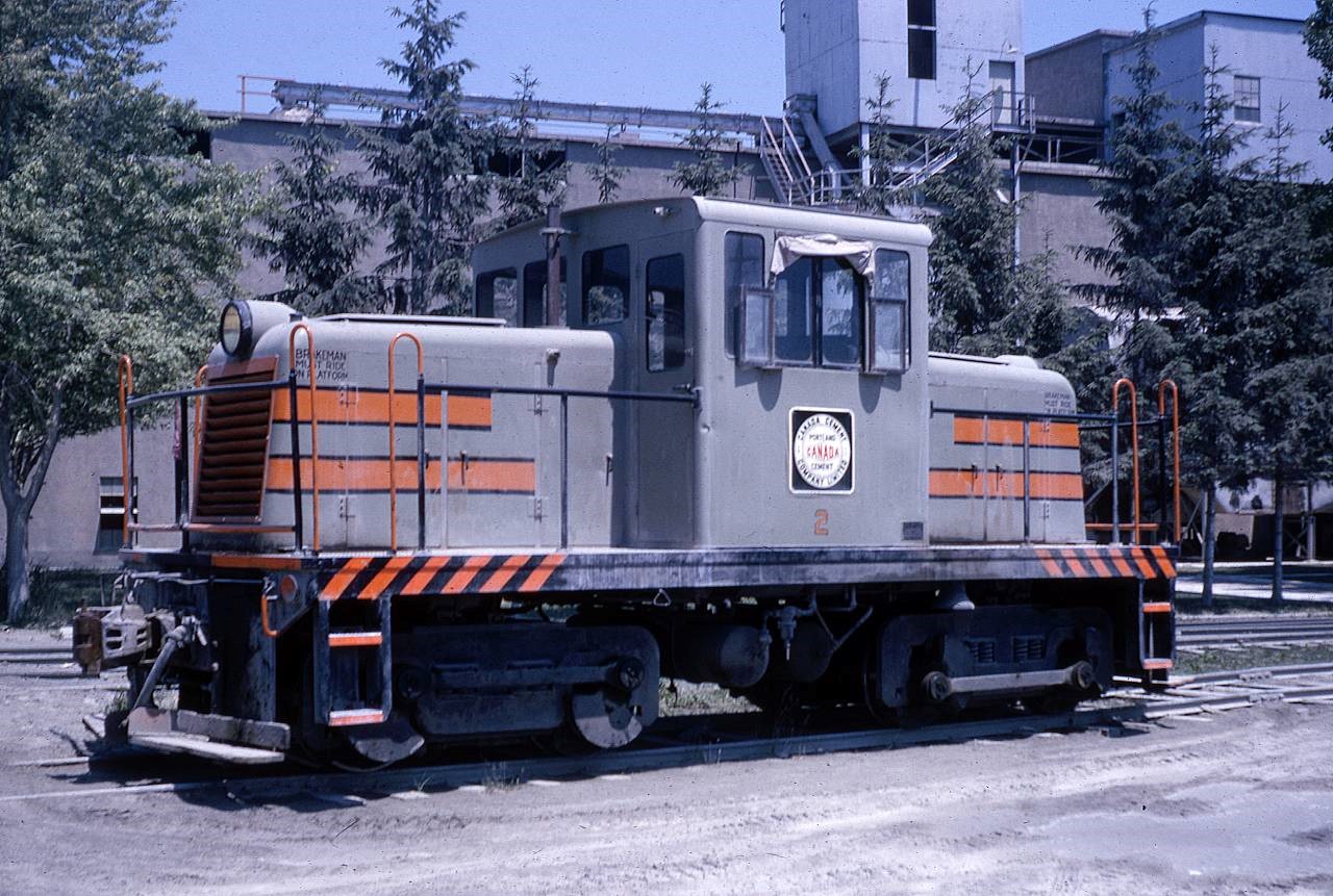 Canada Cement #2 in 1965 on the neatly kept company grounds in Port Colborne.  According to Colin Churcher’s Industrial locomotive guide, Canada Cement Port Colborne received two (2) new 45T units from GE in 1946.  The #2 GE unit was sold to Quebec Iron & Titanium in 1968, and the sister #1 unit to ZALEV Brothers in Windsor (relocated to PSTR in recent years and undergoing restoration now).  The plant existed in Port from the early 1900’s and ceased operations around 1969.  It was taken down shortly after including all the Company housing on what was Maple Avenue (now  Elgin Street west of Steele -  Portal Village Complex).  Canada Cement had their own spur that connected the factory with loading docks on the Welland Canal.  The spur crossed the NS&T (later CN Elm Street Spur) on diamond, and also had a Wye connection onto Elm Street.  In addition, the plant operated a line immediately parallel to the Dunnville Sub (south side) from the factory east of Cement Plant road approx. 3 km west to Quarry Road in Wainfleet.  Canada Cement operated at least 9 facilities across the country and the Port Colborne facility was a major employer with a very extensive network of rail lines inside and outside of their property.  The plant sat on the north side of Macey Yard which is still occasionally used for car storage by GIO.  Canada Cement was eventually sold to LAFARGE, and probably the most impactful legacy of the Company Key Man was the creation of Butchart Gardens in Victoria BC by Jennie Butchart, wife of Canada Cement shareholder Robert Butchart.