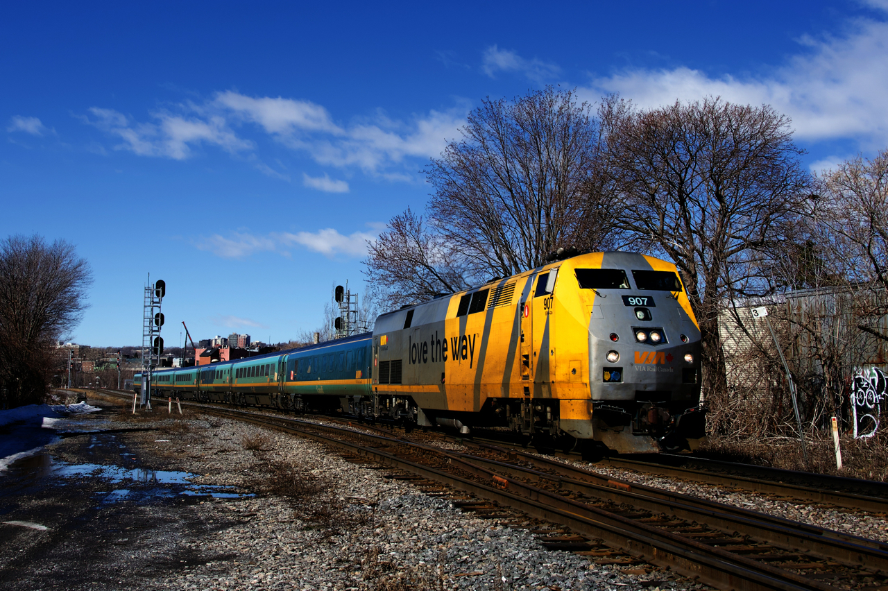 VIA 24 has VIA 907 and seven Renaissance cars as it passes MP 3 of CN's Montreal Sub. In the distance at far left VIA 35 is lined on the south track.