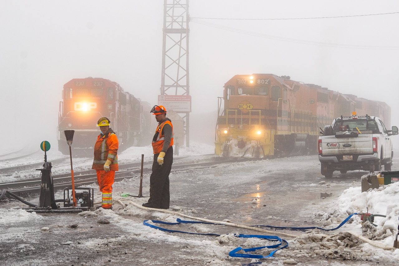 A side of railroading that most of us don't ever have to witness. A moderate ice storm swept through Sudbury overnight, followed by warm temperatures and a thick fog for good measure. CP crews are working to pump water out from switches in the yard, an important task before we returned to seasonal temperatures the following day and everything froze solid again. Based on the three-foot-deep snow I trudged through the day before, there's going to be a lot more pumping to come this year. Here, HCRY 913 gets ready to head west next to the waiting U52 (I thought I heard 52, but U55 is the job mostly working the yard so I'm doubting myself).Also of note, the left worker (never got his name) told me a story of a woman who had some sort of episode and drove a brand-new pickup through the yard, crashing into a couple of tank cars in two different locations before coming to a stop across and far up the tracks by the station. If you know any workers in Sudbury, get them to tell the story and show you photos some time. Hope she's doing alright.