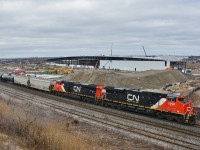 <br>
<br>
   A pair of GEVO-12's roll east at the site of the GO Transit Whitby Rail Maintenance Facility WRMF.
<br>
<br>
   One year old ES44AC  CN #2948 (GE February 2015) and September 2014 GE built CN #2871 with a mixed consist.
<br>
<br>
   From the now removed Hopkins Street overpass (removed late 2016), February 29, 2016 digital by S.Danko.
<br>
<br>
