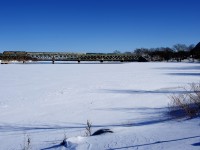 VIA 15 from Halifax is crossing the Richelieu River on a cold winter morning. VIA 15 is currently running twice a week and arrives in Montreal on Monday and Thursday mornings. Since VIA 14 and 15 were reinstated in August 2021 (after not running since March 2020), this train has been running with back to back F40s and a mixed HEP/Renaissance set of cars, and no Park Car. This is because the train can no longer be turned on a balloon track in Halifax, with PSA Halifax (the owner of a container terminal) having taken back access to that track in November 2020. The power has to be back to back as it runs around the train and the first car on eastbound VIA 14 becomes the last car on westbound VIA 15.