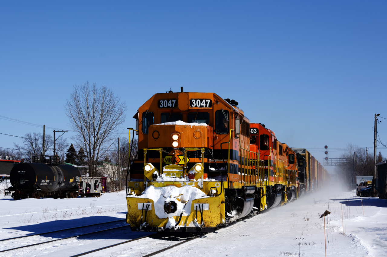 SLR 393 has left the Sherbrooke Sub and is now on the St-Hyacinthe Sub as it approaches St-Hyacinthe Station with four EMDs (SLR 3047, RLHH 3043, SLR 3007 & QGRy 6904) and 42 cars.