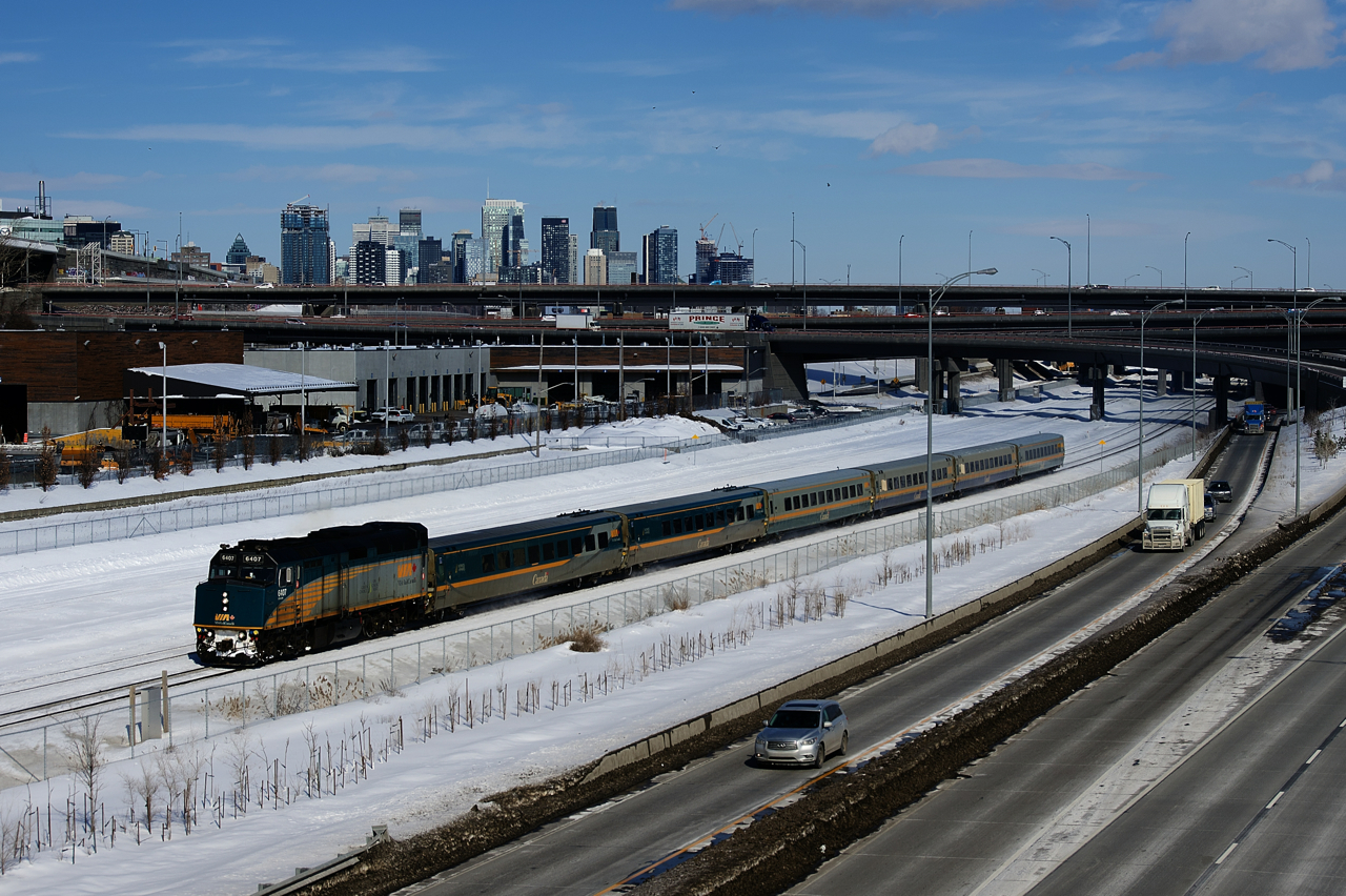 VIA 67 has six LRC cars as it passes the skyline of downtown Montreal.