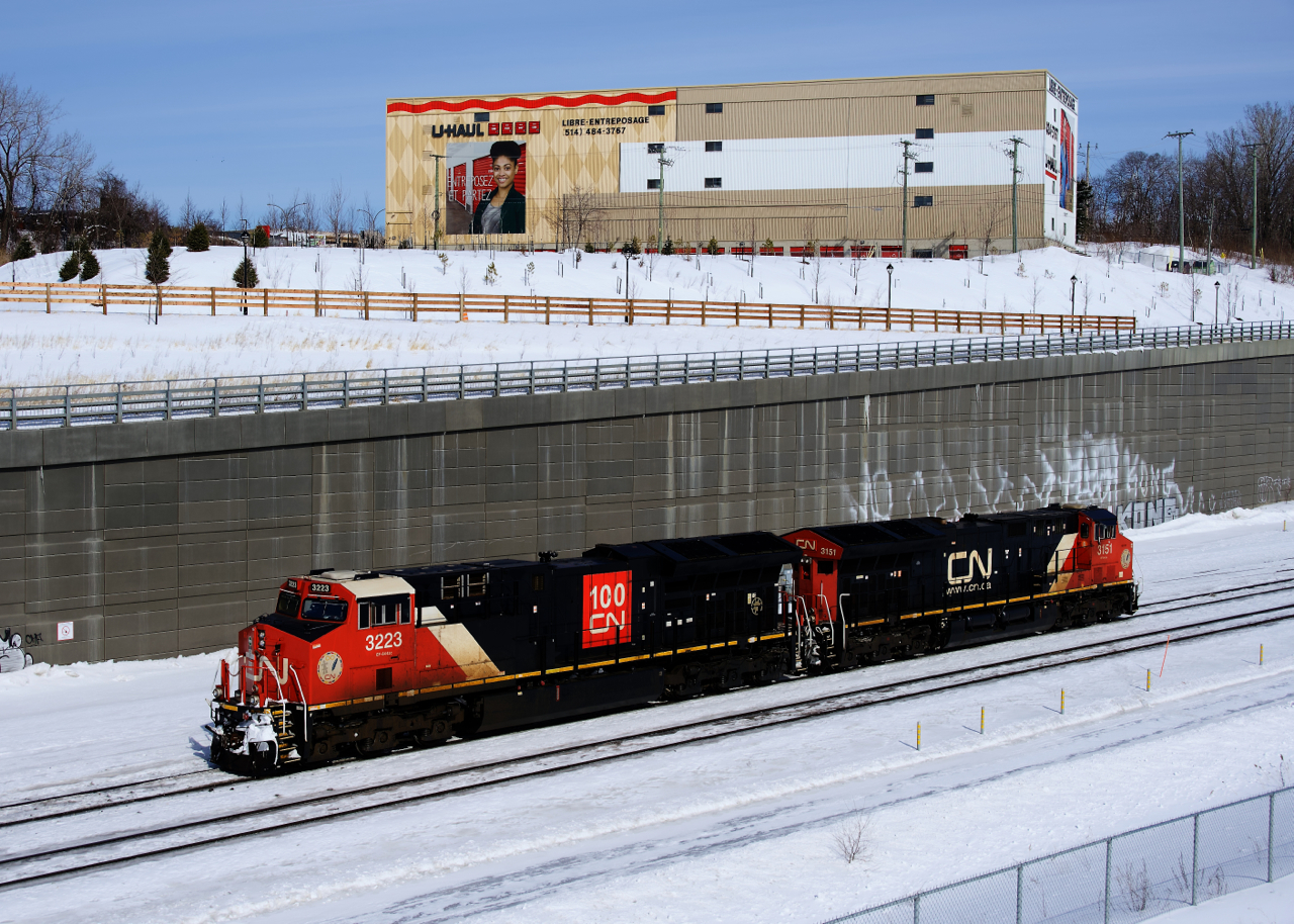 CN X309's light power (ET44ACs CN 3223 & CN 3151) is arriving at Turcot Ouest from Taschereau Yard and is about to couple onto the tied down train. Once derails have been removed from both end of the train and the air pumped, the train will continue westwards.