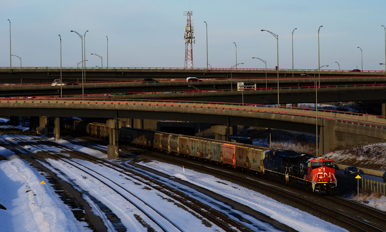 CN 731 has CN 3270, GECX 2037 and 151 potash empties as it emerges from the Turcot Interchange close to sunset.