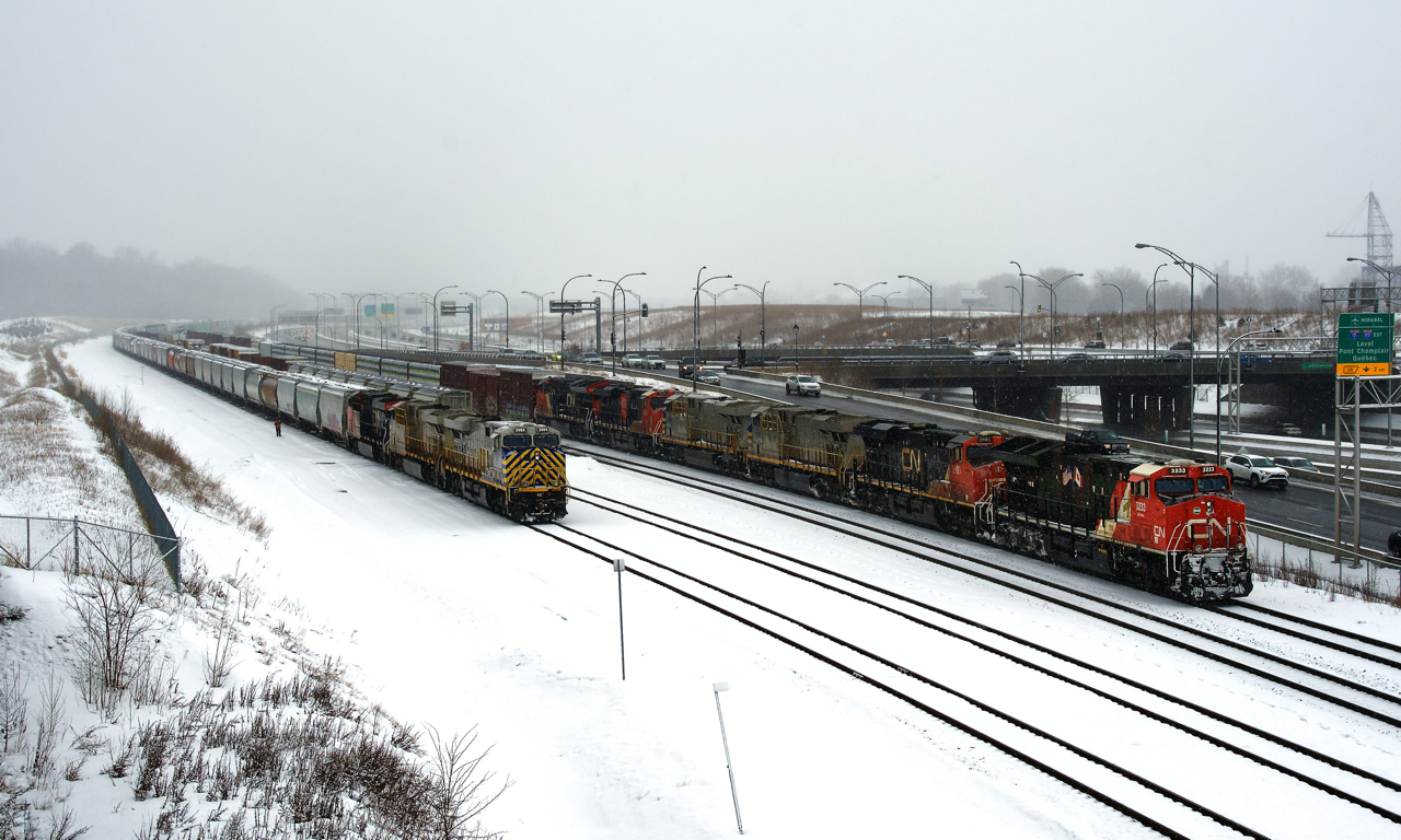 CN 305 at right has a lot of power as it awaits its signal at Turcot Ouest with Veterans unit CN 3233 leading. At left CN 522 has two ex-CREX units up front as it sets off cars on Track 29. For the record, CN 305 has CN 3233, CN 2903, CN 3932, CN 3982, CN 3890 & CN 3143 up front (and DP CN 2974) and CN 522 has CN 3984, CN 3941 & CN 2984.