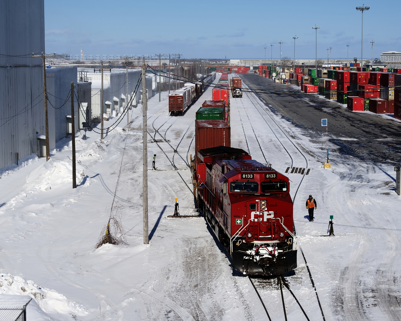 A conductor is getting ready to throw a switch as CP 112 arrives in Lachine IMS Yard.