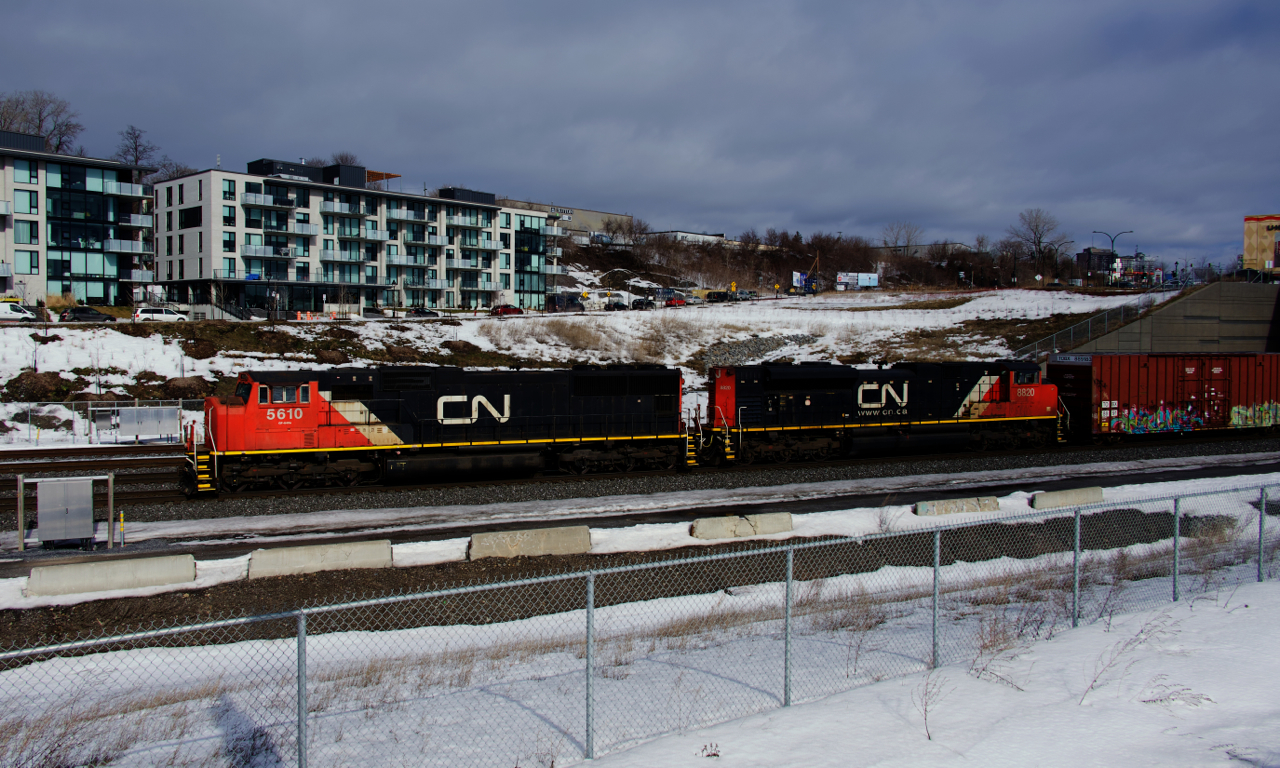 A pair of EMDs (CN 5610 & CN 8820) lead CN X309 westwards.