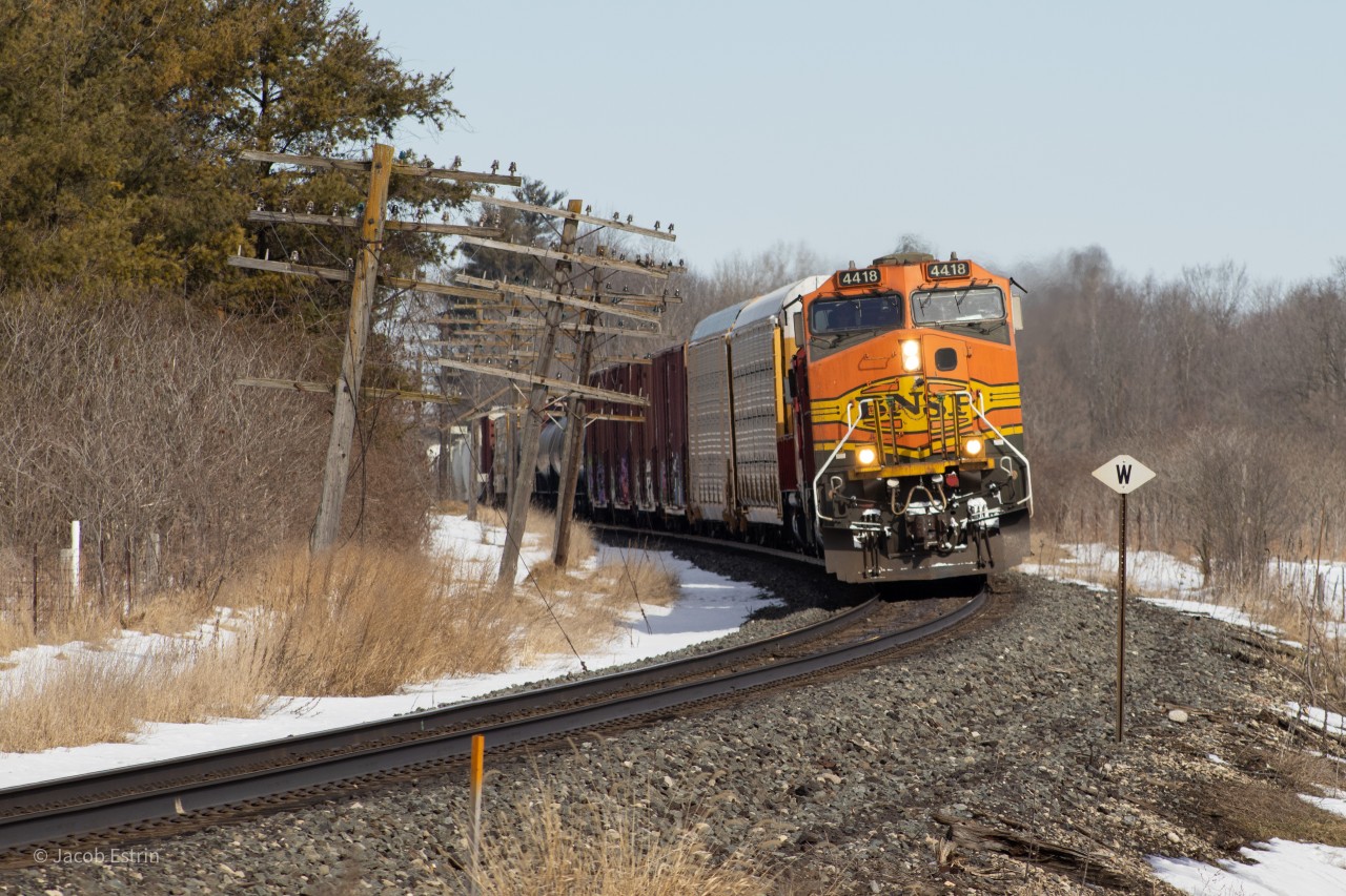 BNSF 4418 is in the lead of 141-04 as it flies through the countryside approaching Ayr.
