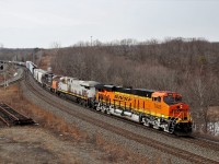 A bright new BNSF 7928 with CN 3951 and CN 5731 glide down the grade on the final stretch of the Dundas sub on the approach to Bayview. The lack of sun didn't help but the bright orange paint sure popped against the dull winter background.