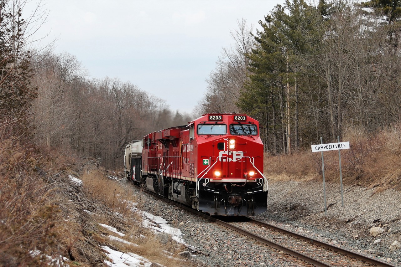 Interesting that Mr. Host posted a photo of CP 8203 in its GP9u days a little earlier and here is a later version with new paint from the former AC4400CW (CP 8514) now refurbished and renumbered to AC4400 CWM, CP 8203 as it passes the Campbellville sign on its way south down the Hamilton sub.
