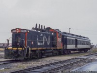 Mixed train 273 moves about the yard at Hearst while preparing to board passengers for it's westbound run.  The nose of another SW1200RS can be seen just beyond the combine.  Situated along the original National Transcontinental Railway line, built through the area in 1913, Hearst lies at the west end of the Kapuskasing Subdivision (Coachrane, mile 0 - Hearst, mile 129.1) and the east end of the Pagwa Subdivision (Hearst, mile 0 - Nakina, mile 144.1).  Situated away from CN's mainline, the Kapuskasing and Pagwa Subs saw few upgrades and deferred maintenance over the years resulting in equipment restrictions on both lines.  The Pagwa Sub specifically was still largely comprised of rails smaller than 80lb resulting in SW1200RS units being the heaviest permitted on the line, giving us the interesting scene here.<br><br>Officially mixed trains 272/273 in the timetable, and operated by VIA Rail by the time of this photo, the trains no longer operated with freight in the consist as only one customer remained on the 144.1 mile line, Arthur Lecours Limber Mill at Calstock (mile 22.7).  It would typically be serviced by a job from Hearst.  There is not long left for trains 272/273.  With virtually no traffic on the line, attributed to the mainline further south, and deferred maintenance restricting load capacity, CN's request to abandon the Pagwa Sub west of Calstock would be approved, with the rails lifted in 1986.  In August 1993, the Kapuskasing Sub and Pagwa Sub to Lecour's mill would be sold to the Ontario Northland Railway.  Information per Chris van der Heide and his website, <a href=http://vanderheide.ca/blog/2015/12/04/cn-operations-at-hearst/>Algoma Central in HO Scale (more info on Hearst here).</a><br><br>By this time, the original <a href=http://www.railpictures.ca/?attachment_id=23918>Hearst station</a> had been retired but still stood with it's smaller replacement a few feet to the west (a seen in Arnold's linked image, and soon in a part 2 of this image).  <br><br>CN 1392, built by GMD in 1960, would meet an untimely end on November 9, 1997 while assigned to the to the Shawinigan Falls Terminal Railway after being destroyed by a landslide.  It would be chopped up onsite.<br><br>More 1392<br><a href=http://www.railpictures.ca/?attachment_id=34919>Pups through Bayview,</a> Dave Burroughs, 1967<br><a href=http://www.railpictures.ca/?attachment_id=47516>Departing Toronto Yard,</a> First954, 1969<br><br><i>Don Jilson Photo, Jacob Patterson Collection slide.</i>