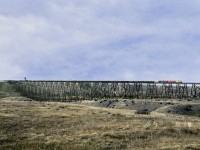 Eastbound oil empties from the UP interchange at Kingsgate to the North Dakota Bakken field south of North Portal Sask. has just departed Kipp Yard and is crossing the Lethbridge viaduct over the Oldman River. The bridge is 5327' long and 307' high making it the longest and highest deck trestle in the western hemisphere
