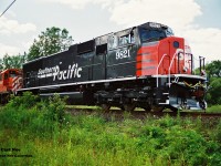 Southern Pacific SD70M 9821 gets its first baby pictures taken as it is lifted at the GMDD facility in London, Ontario by a CP westbound powered by SD40-2’s 5841 and 5657.