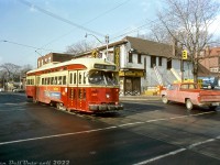TTC PCC 4371 rattles through the intersection of Queen Street and Beech Avenue, heading eastbound through "The Beaches" neighbourhood on the Queen route for nearby Neville Loop. The Dodge pickup appears to be waiting to make a left-turn or U-turn at the intersection.<br><br>The Chalet Steakhouse, Restaurant & Tavern in the background appears to be undergoing renovations. The building remains today, home to a local watering hole.<br><br><i>Original photographer unknown, Dan Dell'Unto collection slide.</i>