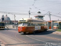 Freshly rebuilt TTC A7-class PCC 4496 pulls out of Dufferin Loop, signed up for the Dundas route but actually one of the chartered cars operating on a fantrip for the <a href=http://www.railpictures.ca/?attachment_id=37233><b>Electric Railroaders Association convention</b></a> in Toronto. Two of the TTC's GM NewLook (fishbowl) buses, 7145 (left) and 3918 (right), are seen operating on the 29 Dufferin route serving the CNE (background). 
<br><br>
The TTC's Dufferin Loop was one of the main transit access points to get to/from the Canadian National Exhibition grounds (via the Dufferin Gate entrance here). The girdered bridge next to 7145 spans CN's Oakville Subdivision rail corridor, and this spot was also once home to the old CN/GO Exhibition station for the same purpose (until relocation by GO Transit to its <a href=http://www.railpictures.ca/?attachment_id=46613><b>present location</b></a> to the east in the late 60's).
<br><br>
<i>J.D.(Dave) Morgan photo, Dan Dell'Unto collection slide.</i>