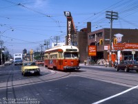 <b>A trip down St. Clair</b><: TTC PCC 4514 (as a 1951-built A8-class, the "newest" PCC's in the fleet) heads eastbound on St. Clair Avenue West on the 512 bound for the Yonge Subway line (St. Clair station loop). It's seen here crossing Vaughan Road, mixed in with afternoon traffic. I spy an early Honda Civic, an International Harvestor S-series truck operating for Maritime Ontario, a Mister Donut, a Pizza-Pizza (sporting the old logos), and the Heritage Theatre (formerly the old Vaughan Road Theatre, built in 1947 and demolished in the 80's).
<br><br>
<i>Joe Testagrose photo, Dan Dell'Unto collection slide.</i>
