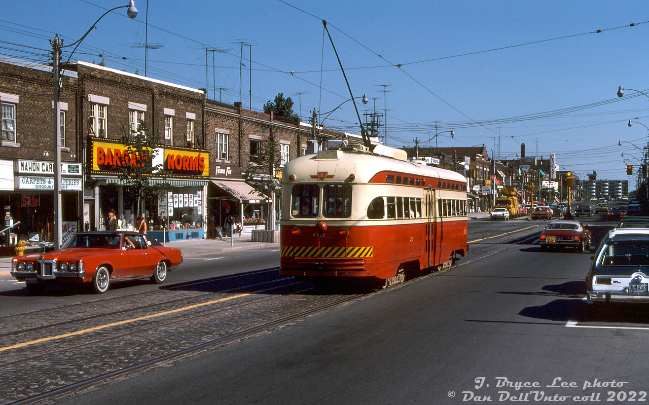 A 1970 Pontiac Grand Prix cruises by some small businesses that lined the street as TTC PCC 4528 passes southbound on the short-lived Mount Pleasant streetcar route during its final week of operation in July 1976. A TTC line truck for overhead work is visible waiting at the light at Manor Road, and beyond that signage for the Crest Theatre. A car nearby sports a yellow "City" plate on back (taxi?). The blue and white AMC Gremlin on the right may have been owned by Bryce (a similar one was seen in some of his other photos).

In the final year of streetcar service on Mount Pleasant Road, the Mount Pleasant portion of the St. Clair streetcar that ran between St. Clair subway station and Eglinton Loop (Eglinton/Mount Pleasant) was separated into its own route, the Mount Pleasant streetcar, that operated until it was discontinued at the end of July 1976.

J. Bryce Lee photo, Dan Dell'Unto collection slide.

More Mount Pleasant streetcar memories:
http://www.railpictures.ca/?attachment_id=37064
http://www.railpictures.ca/?attachment_id=31154
http://www.railpictures.ca/?attachment_id=30929