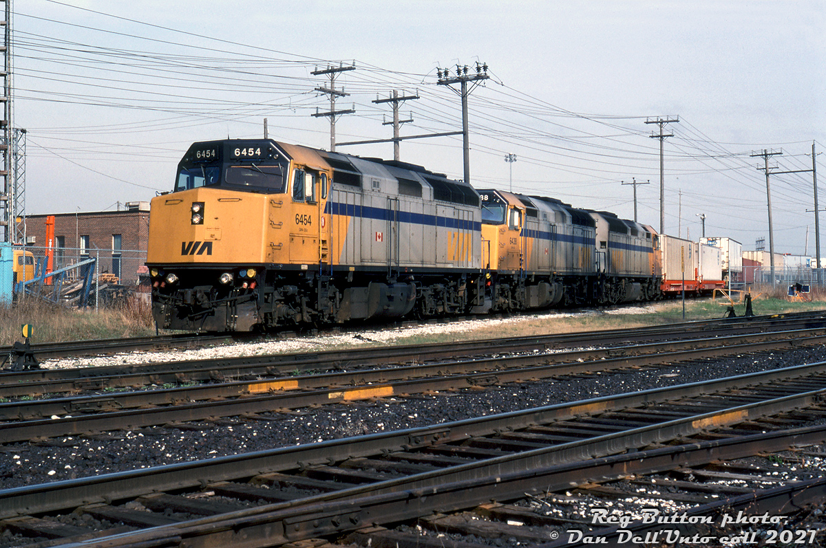 89mph-geared passenger F40PH-2 units are not the best power to use in freight service, but they may have been handy pulling fast intermodal trains. Power-short CP in the early 90's was a gaggle of leased power mixed with the usual CP power of the era (C424's, big M's, rebuilt RS18's and GP9's, GP38's and SD40's of many flavours). Cuts in VIA's passenger train network in the early 90's left VIA with surplus equipment, and CP was able to twist VIA's arm to get 4-8 of their F40's for use in freight service. Unlike other old and worn-out leasers on hand, the VIA units weren't that old, being built by GMD in 1986-89 they were still relatively new! 

One of their typical uses was on intermodal trains #929 and #928 between Montreal and Toronto, often in back-to-back pairs or mixed with CP freight and leaser units for heavier trains. Despite being 3000 horsepower, the high 89mph gearing limited their pulling power in freight service, hence running with other power.

A solid consist of three VIA F40's on a freight train would have been rare! But on this day, Reg Button was on the scene in Toronto to capture this trio of leased F40's 6454, 6438 and 6452 heading up CP intermodal train #929, seen at the south end of CP's Obico intermodal yard near North Queen Street crossing in Etobicoke.

Reg Button photo, Dan Dell'Unto collection.