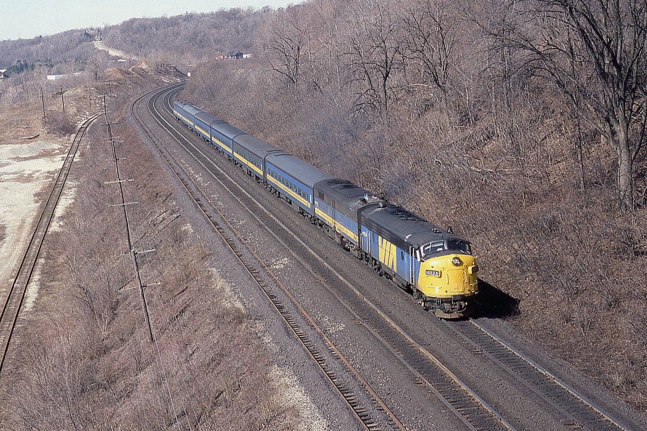 Over the years on this site I thought I had dug out most of the decent shots taken from the Canada Crushed Stone conveyor overhang at Dundas sub mile 4; but here is another one. It was a fun spot  (but dangerous) while it lasted. From high up here is VIA 6524 and 6623 running an eastbound passenger. I think it is a bit long to be #84; I have already posted #70 a while back, and it looks too early by the sun angle to be #72. So just guessing.  It is a beautiful early spring day, last day of March in 1982, and in the distance one can see the old Dundas station; not long before a fire scorched it in late 1984 and its eventually demise a few years later.
As far as I can recall after this day of photos I did not go back into the conveyor again, even though it was not dismantled until early 1986. Too risky.